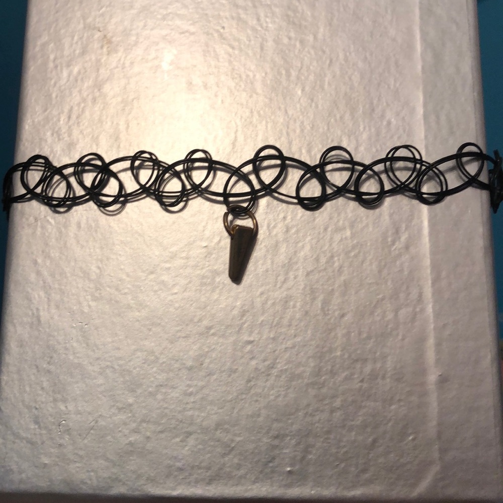 Golden triangle with black choker